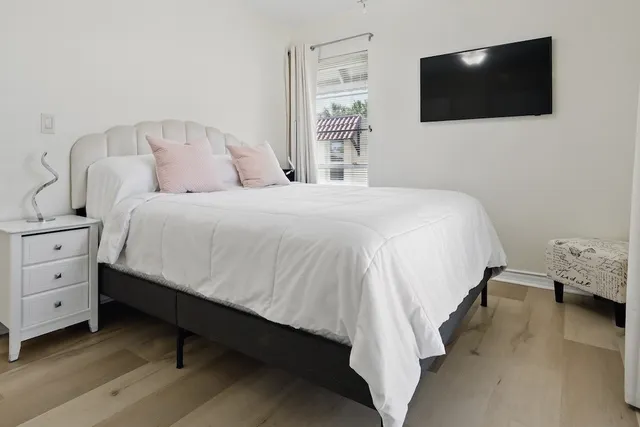 a bedroom with a bed and a flat screen tv