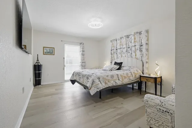 a bedroom with a bed and a flat screen tv