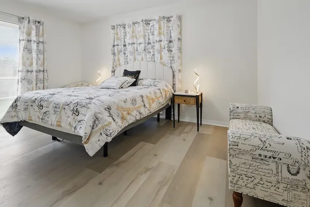 a bedroom with a bed and a chair