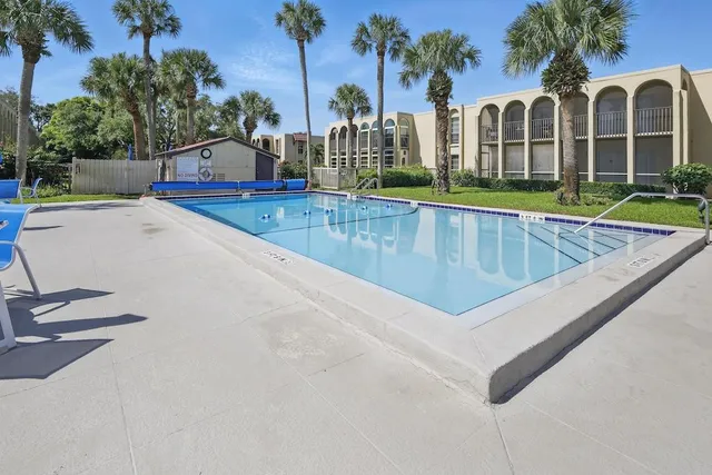 a view of swimming pool with outdoor seating and yard