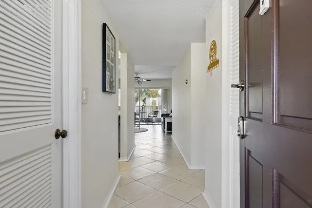 a view of a hallway with living room and dining room view