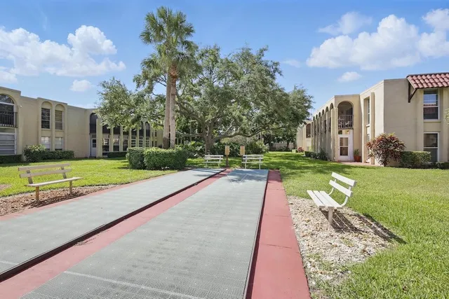 a view of yard with swimming pool and green space