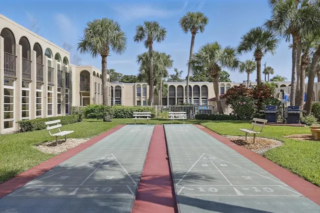 a view of a house with garden and a patio