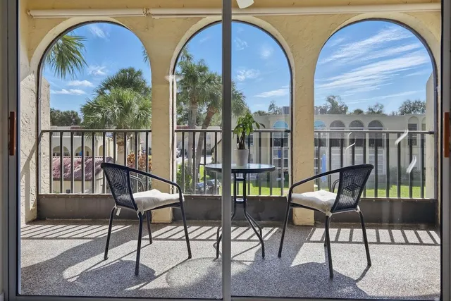 a view of a chairs and table in the balcony