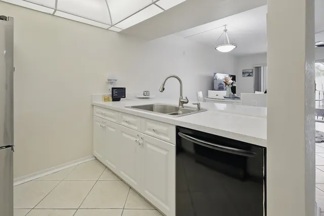 a utility room with sink dryer and washer