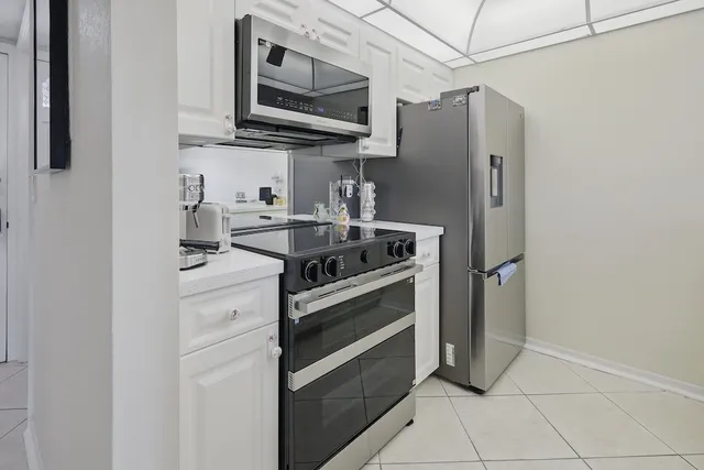 a kitchen with stainless steel appliances granite countertop a refrigerator and a stove