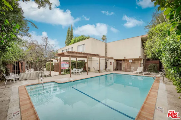 a view of a swimming pool with sitting area