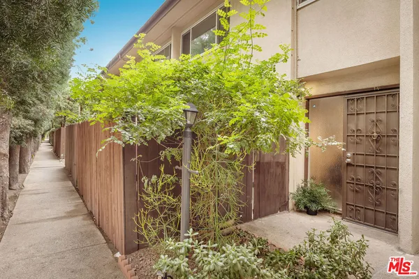 a couple of potted plants in front of door