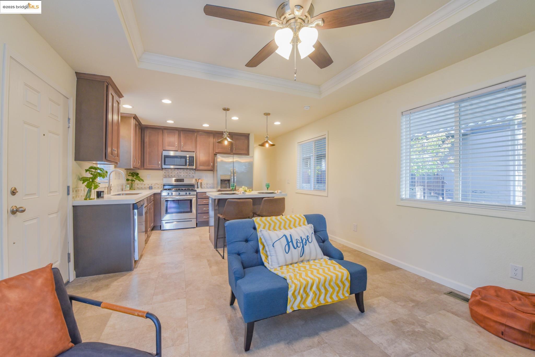 10956 Green Street Columbia, CA 95310 - Photo 26 of 45 Kitchen with a raised ceiling, a center island, appliances with stainless steel finishes, hanging light fixtures, and recessed lighting