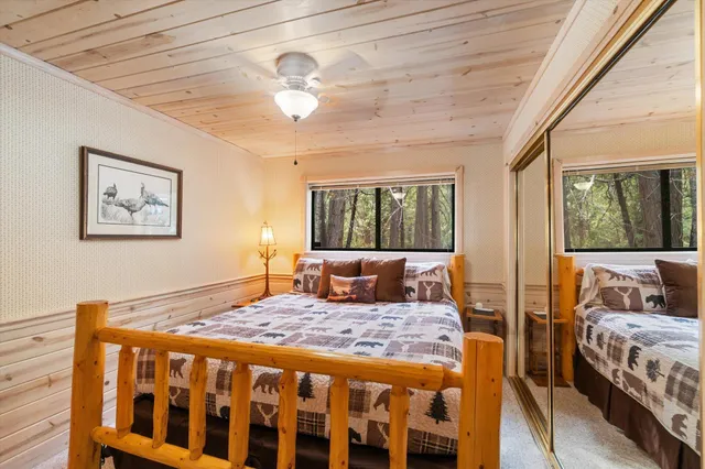 a bedroom with a large bed and a window