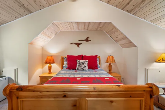 a bedroom with a bed and lamp