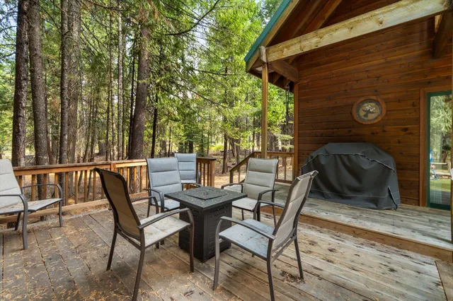 a view of a patio with table and chairs and wooden floor