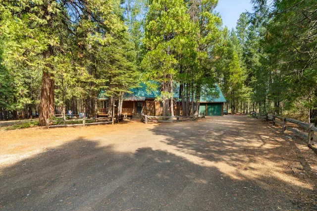 a view of swimming pool with large trees