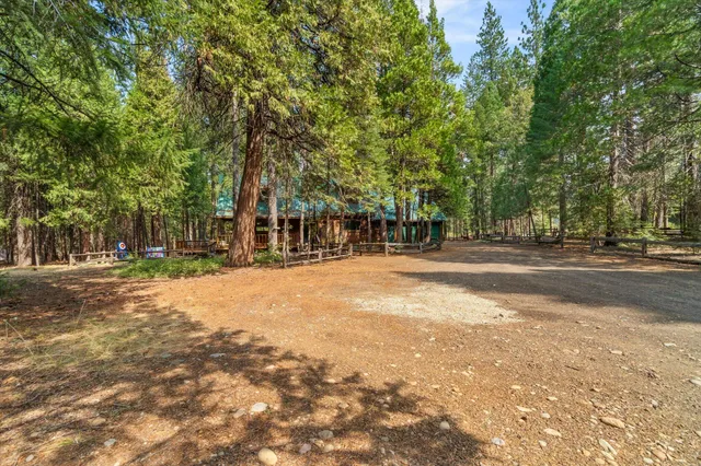 a view of a patio with chairs and table and chairs under an umbrella