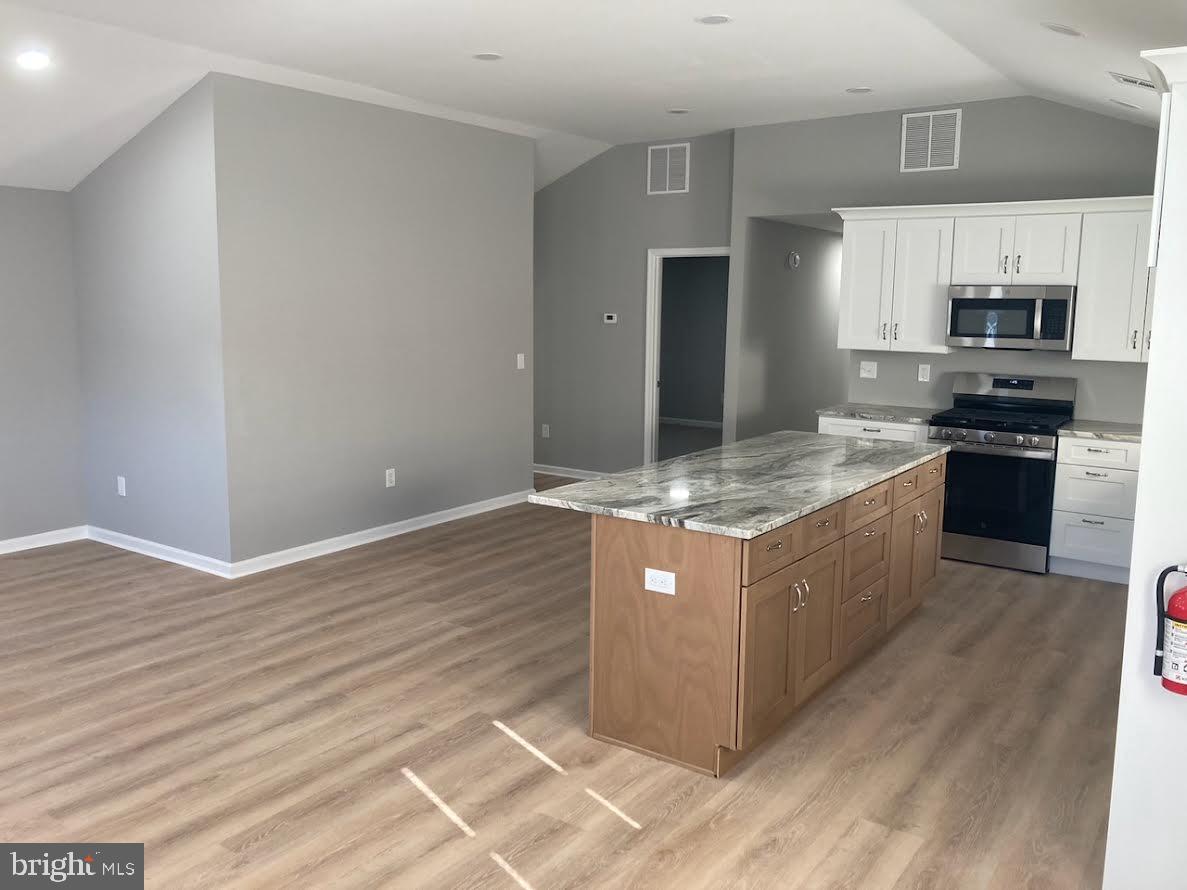 72 Alden Avenue Riverside, NJ 08075 - Photo 15 of 26 a kitchen with stainless steel appliances granite countertop a stove a refrigerator and a sink