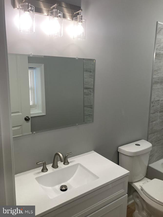 72 Alden Avenue Riverside, NJ 08075 - Photo 19 of 26 a bathroom with a toilet sink and mirror