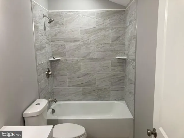 a bathroom with a toilet and bathtub