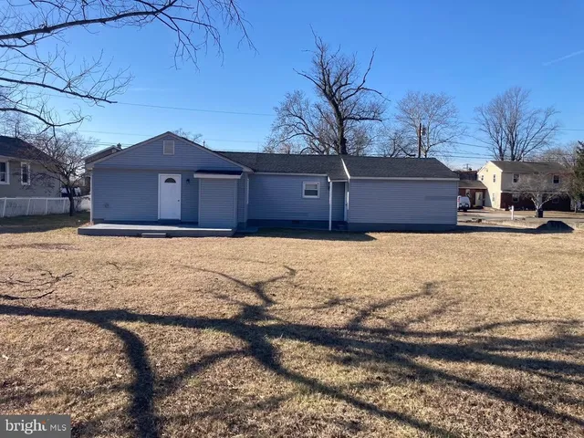 a view of large house with a yard covered with snow in front of house