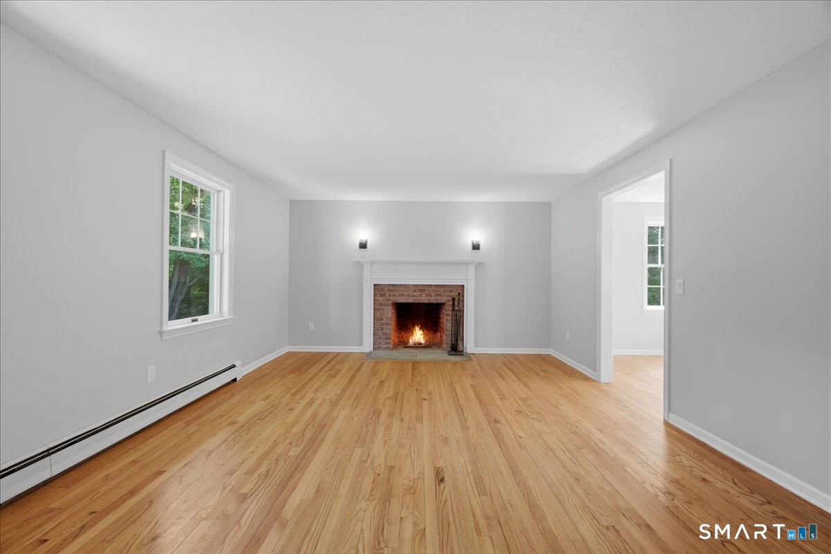 3 Docs Hill Rd. Westbrook, CT 06498 - Photo 15 of 37 Living room with wood burning fireplace
