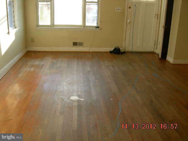 300 Torner Road Essex, MD 21221 - Photo 3 of 10 a view of a room with wooden floor and a window