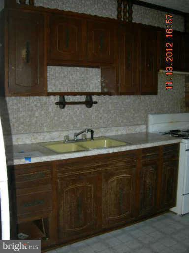 300 Torner Road Essex, MD 21221 - Photo 4 of 10 a kitchen with granite countertop cabinets and sink