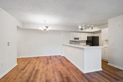 a kitchen with granite countertop a sink stainless steel appliances and cabinets