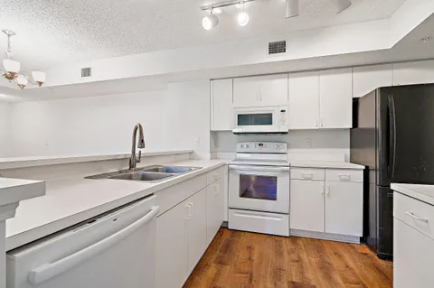 a kitchen with a sink cabinets and appliances