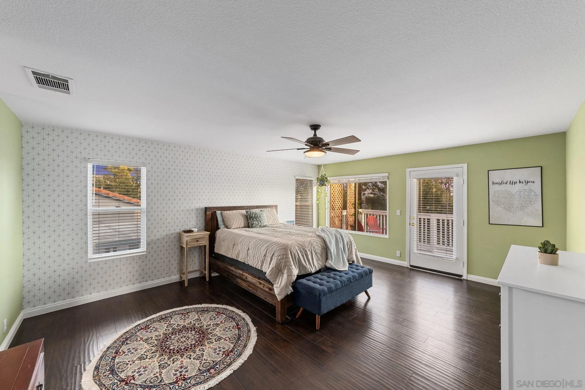 2103 Drew Road Escondido, CA 92027 - Photo 25 of 60 a spacious bedroom with a balcony a bed and wooden floor