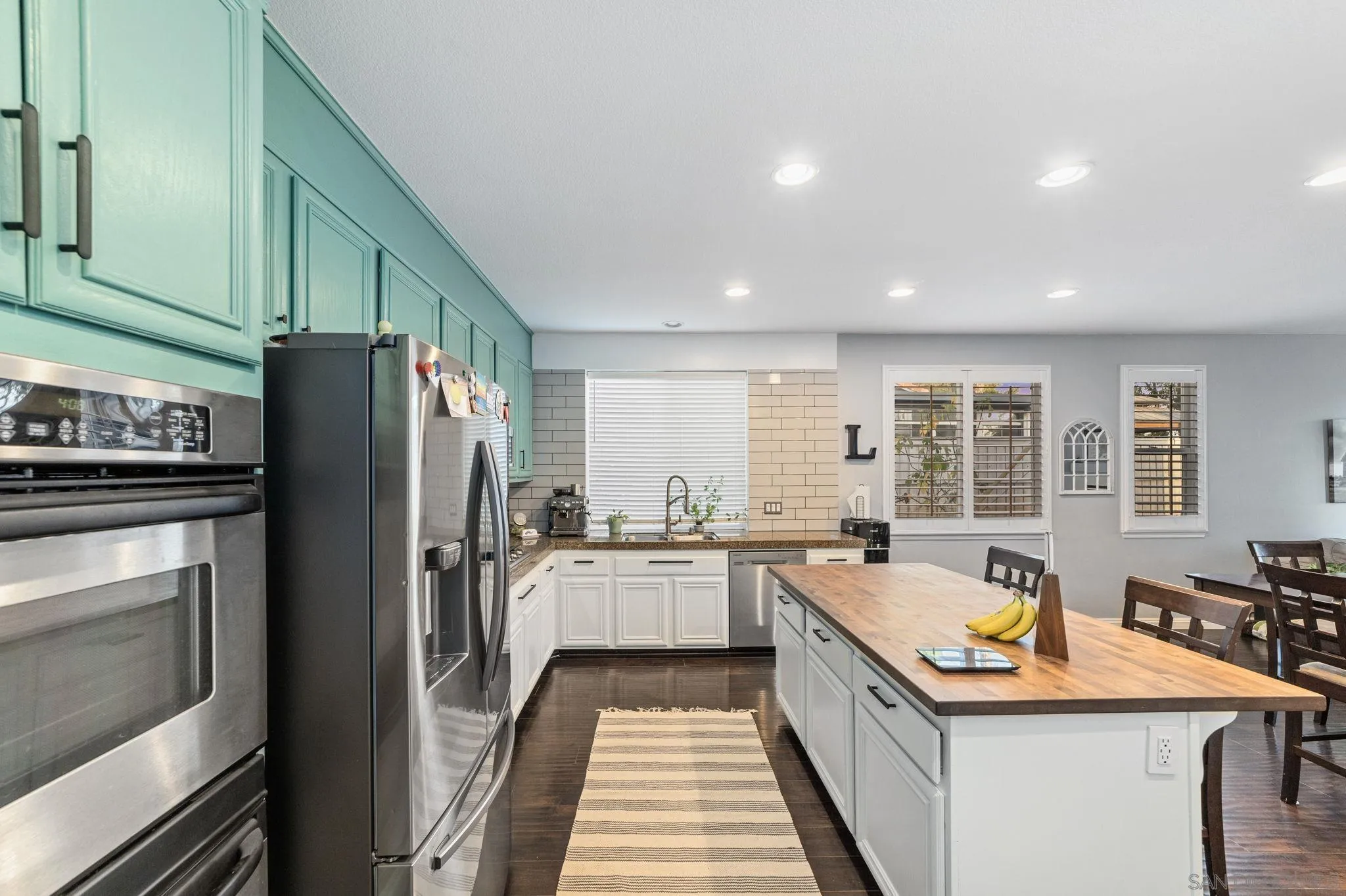 2103 Drew Road Escondido, CA 92027 - Photo 9 of 60 a kitchen with stainless steel appliances granite countertop a stove top oven a refrigerator a sink and dishwasher with wooden floor