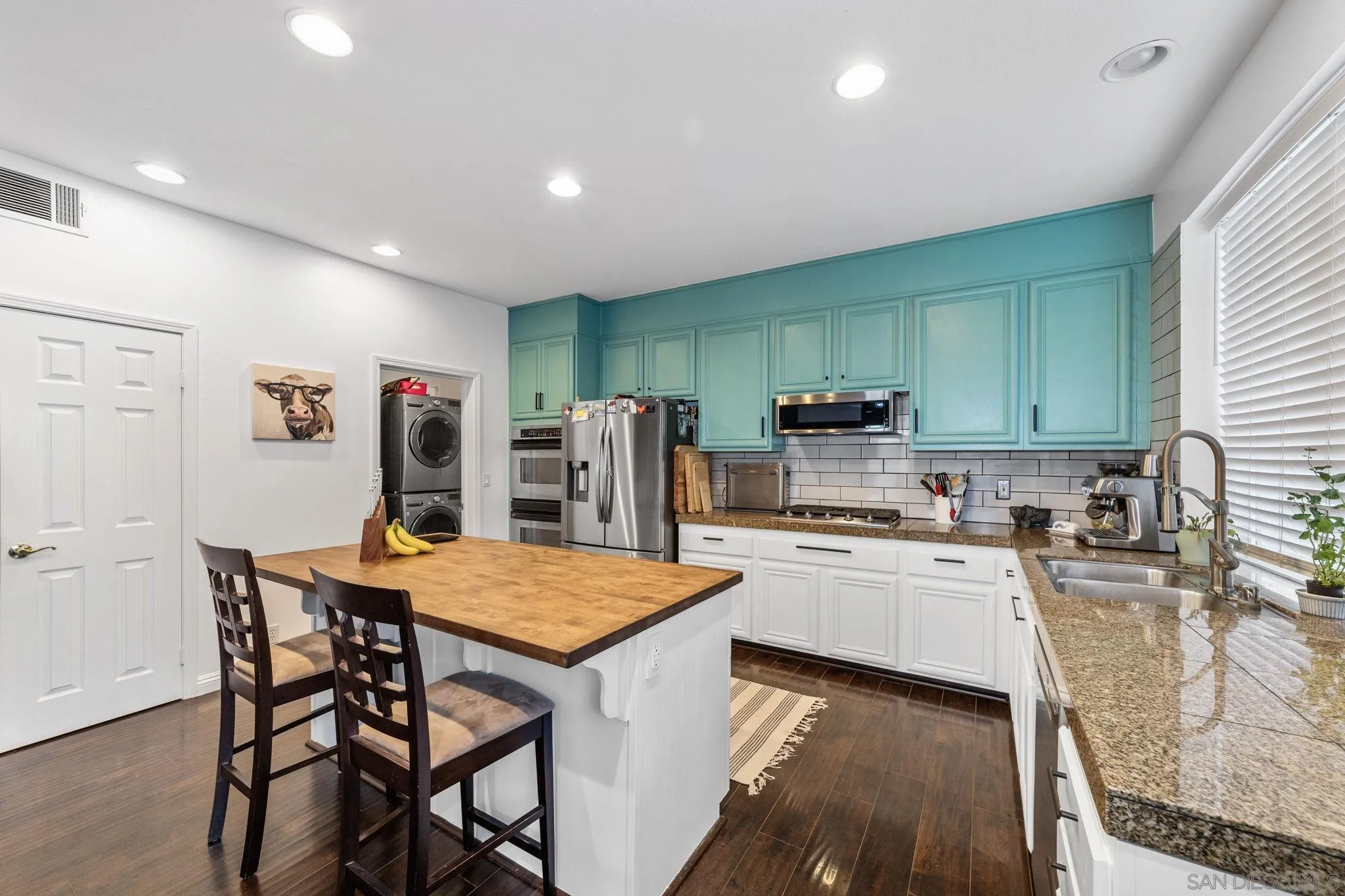 2103 Drew Road Escondido, CA 92027 - Photo 10 of 60 a kitchen with stainless steel appliances granite countertop a stove top oven a sink dishwasher and a refrigerator with wooden floor