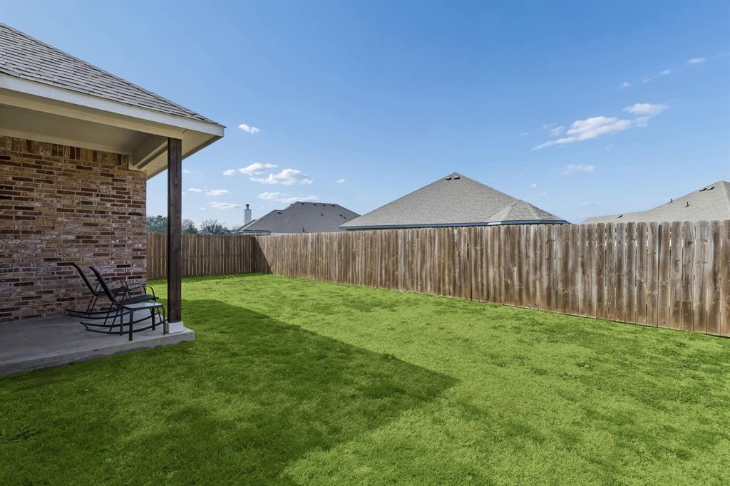 388 Montague Street Pilot Point, TX 76258 - Photo 28 of 28 a view of a backyard with wooden fence
