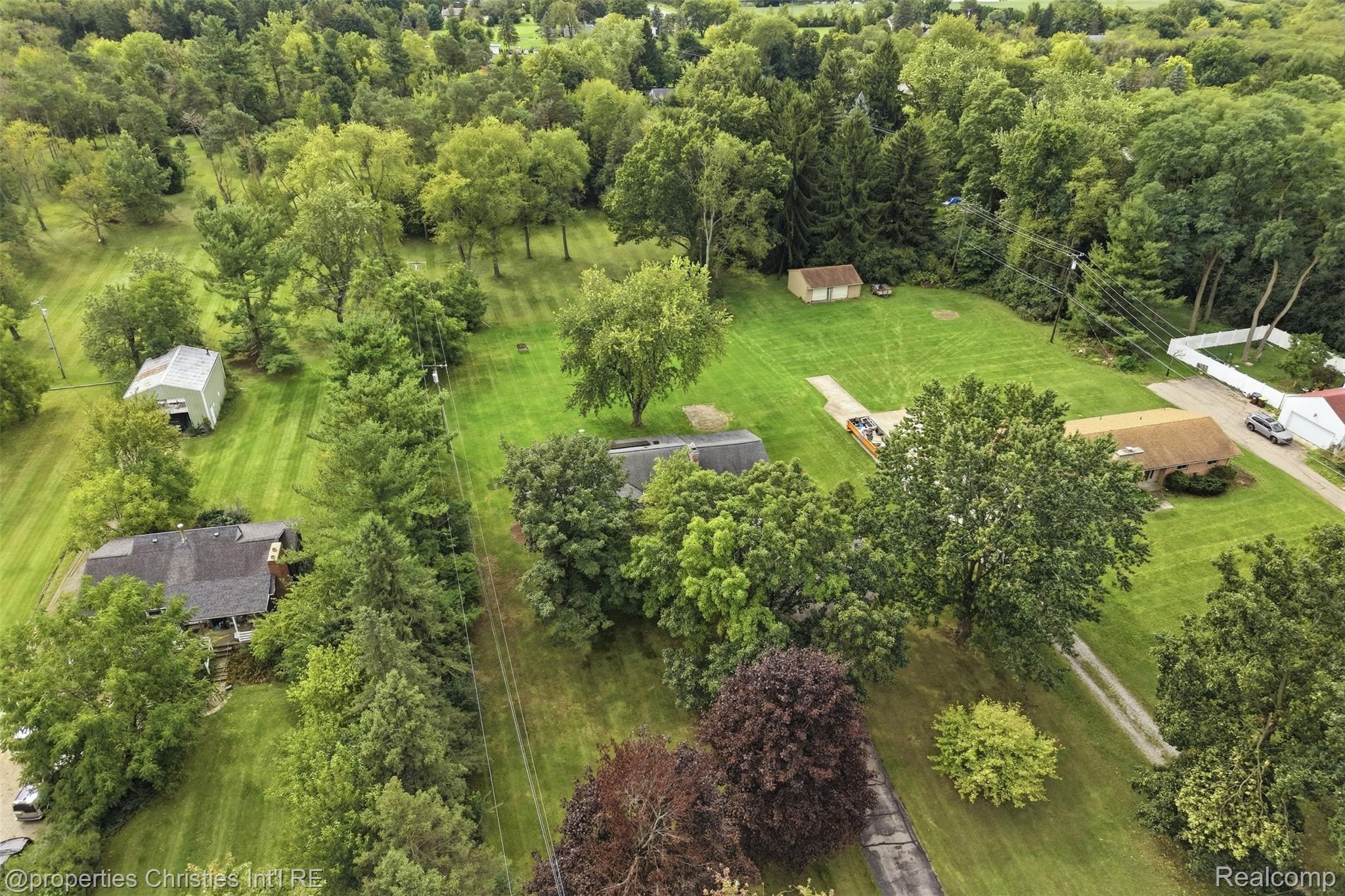 4030 Textile Road Ypsilanti, MI 48197 - Photo 46 of 58 Expansive lot with lush green lawn, mature trees, and multiple residential structures