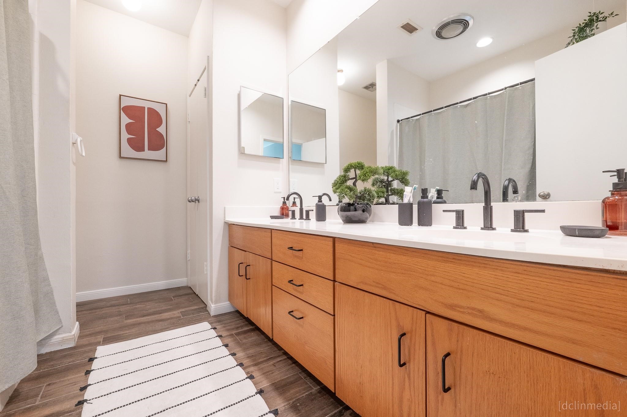 2002 Norfolk Street, Unit A Houston, TX 77098 - Photo 29 of 35 a spacious bathroom with double sink and a mirror
