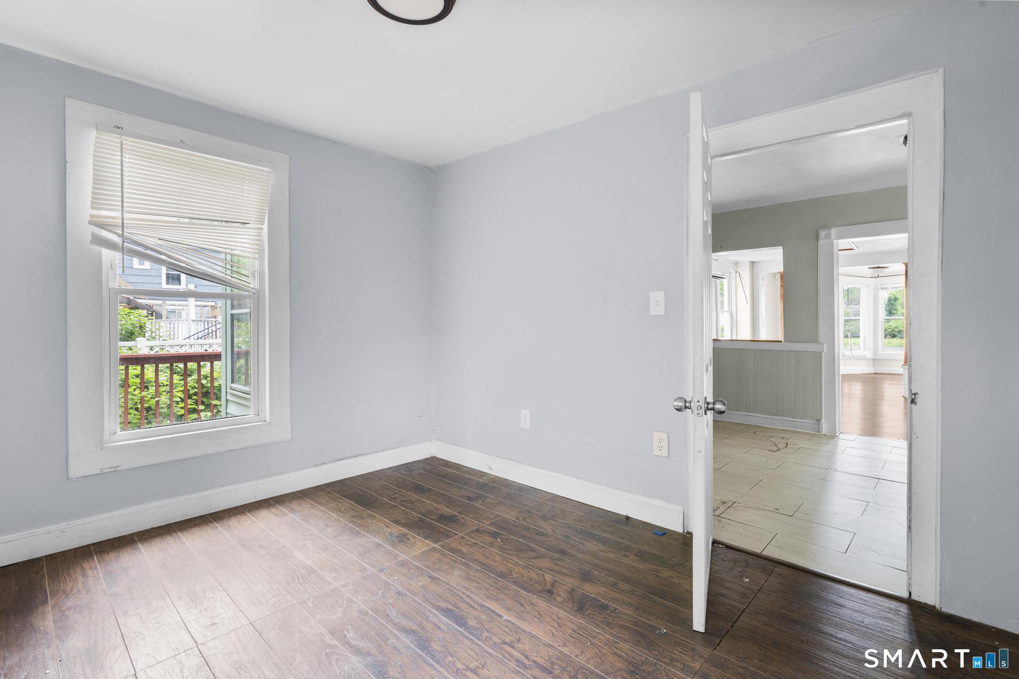 101 Meridian Street Meriden, CT 06451 - Photo 24 of 26 an empty room with wooden floor closet and windows