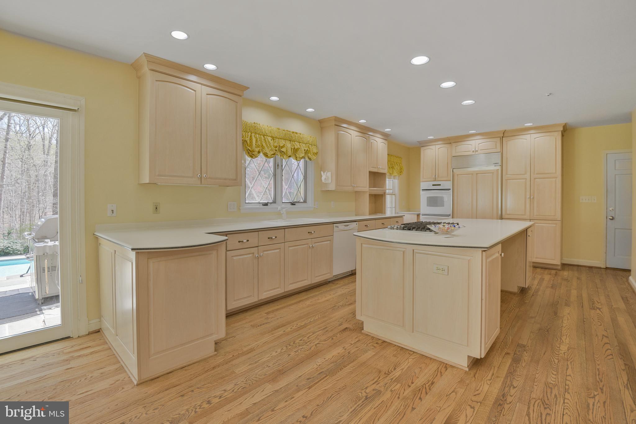 10101 Bentcross Drive Potomac, MD 20854 - Photo 13 of 44 a kitchen with a sink cabinets stainless steel appliances and a window