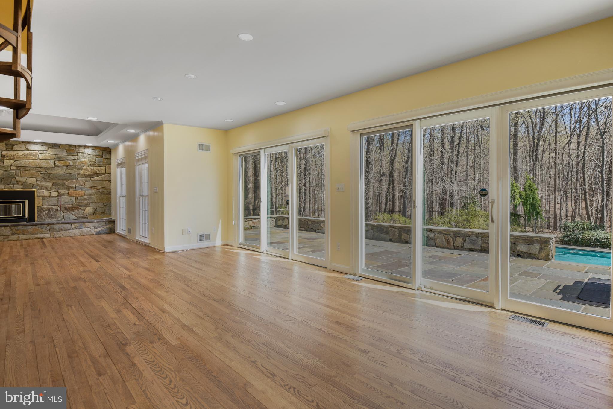 10101 Bentcross Drive Potomac, MD 20854 - Photo 14 of 44 en empty room with wooden floor and sliding door