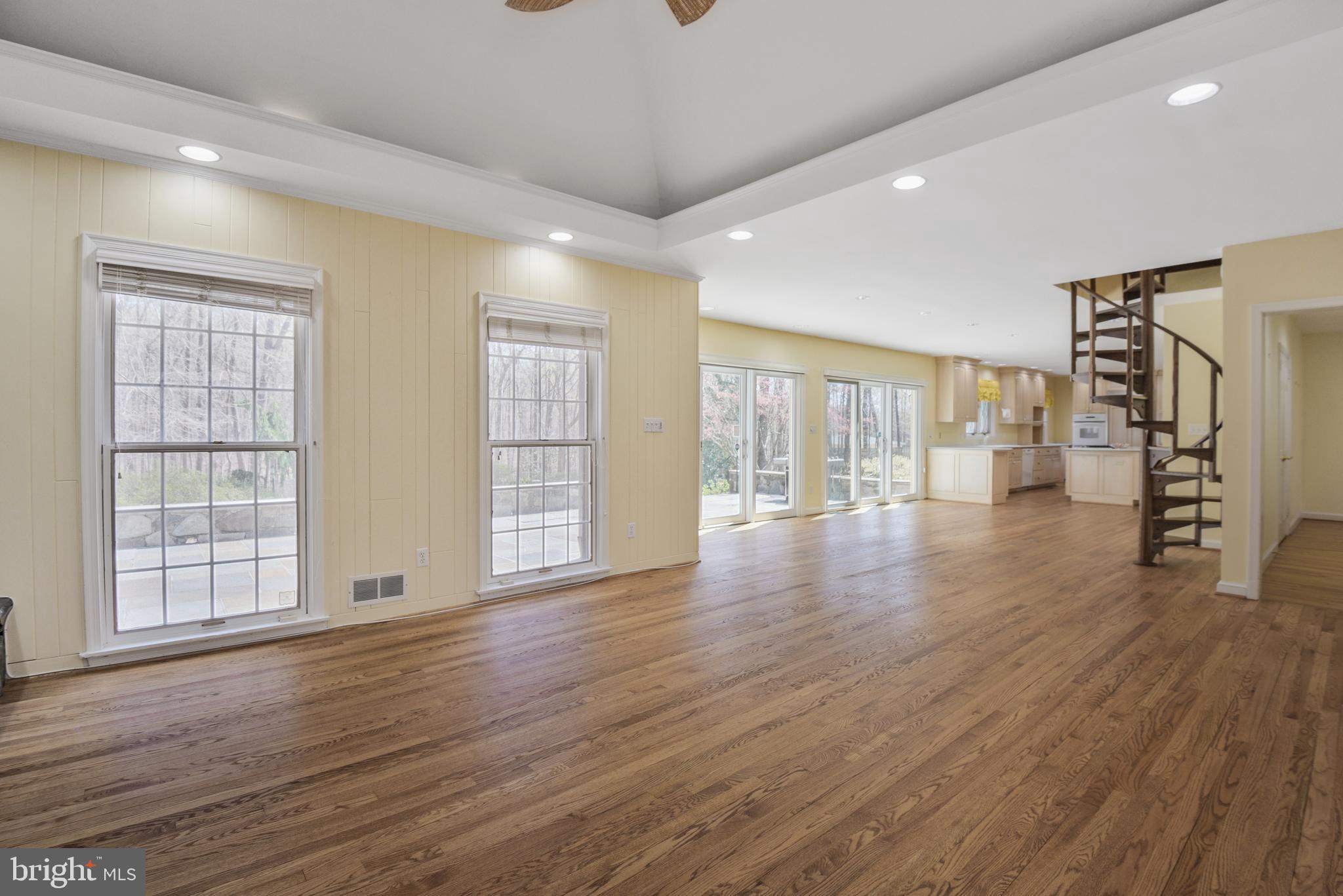 10101 Bentcross Drive Potomac, MD 20854 - Photo 16 of 44 a view of an empty room with wooden floor and windows