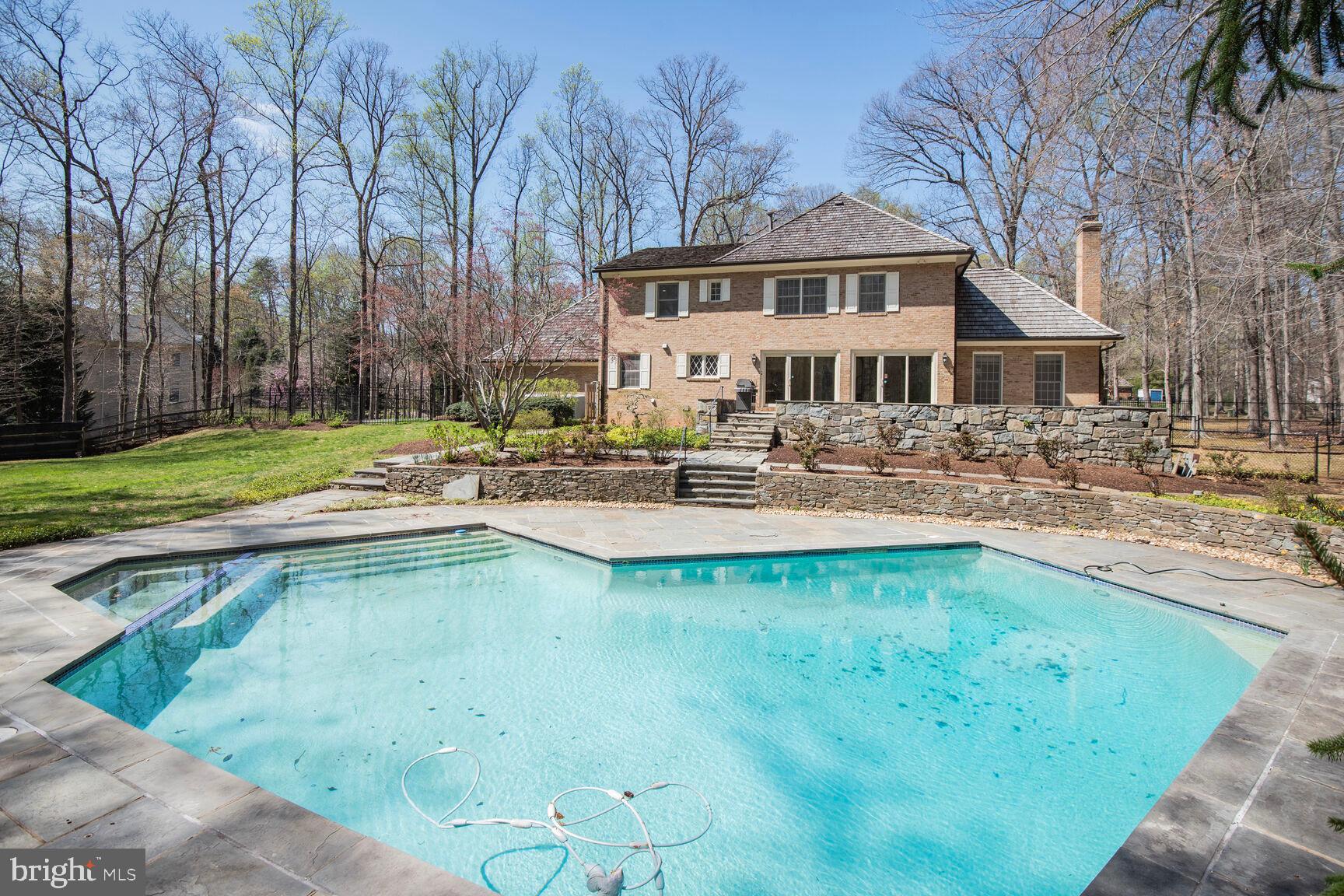 10101 Bentcross Drive Potomac, MD 20854 - Photo 38 of 44 a swimming pool with outdoor seating and yard