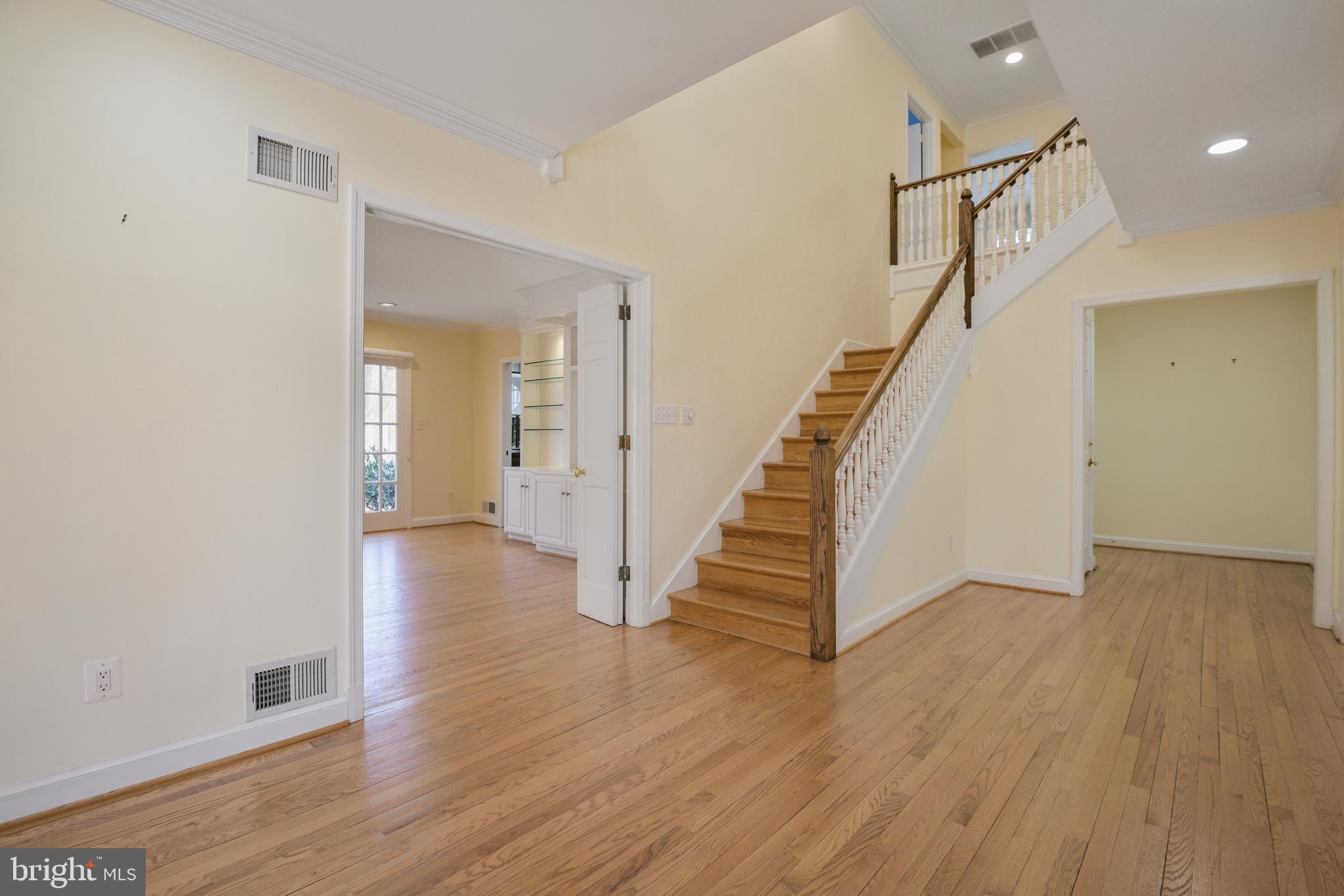 10101 Bentcross Drive Potomac, MD 20854 - Photo 6 of 44 a view of a hallway with wooden floor and staircase
