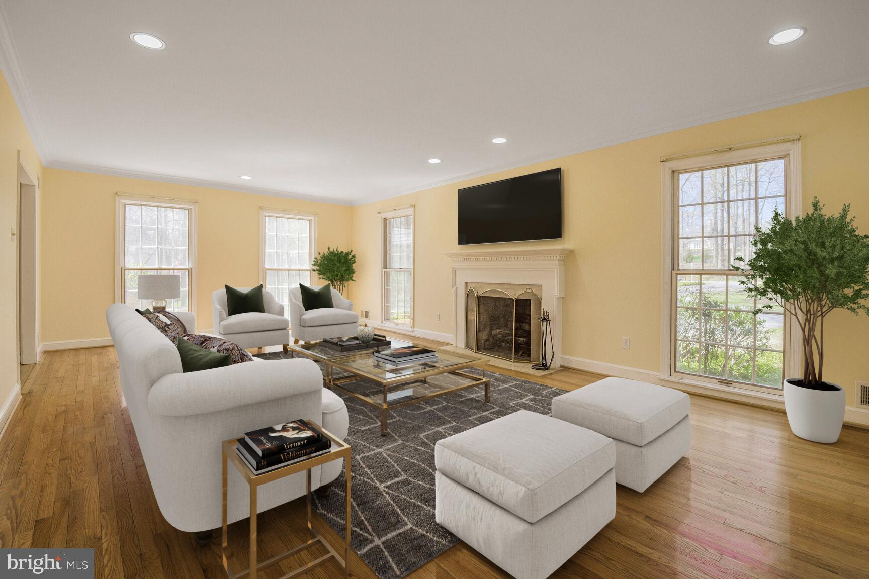 10101 Bentcross Drive Potomac, MD 20854 - Photo 7 of 44 a living room with furniture a fireplace a potted plant and a large window