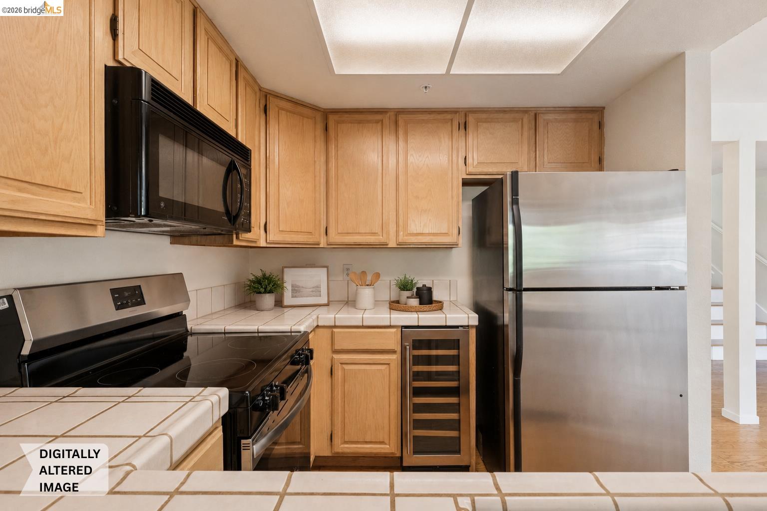 261 Redhawk Road Novato, CA 94949 - Photo 23 of 47 Kitchen featuring light wood cabinetry, tiled countertops, and a tiled backsplash
