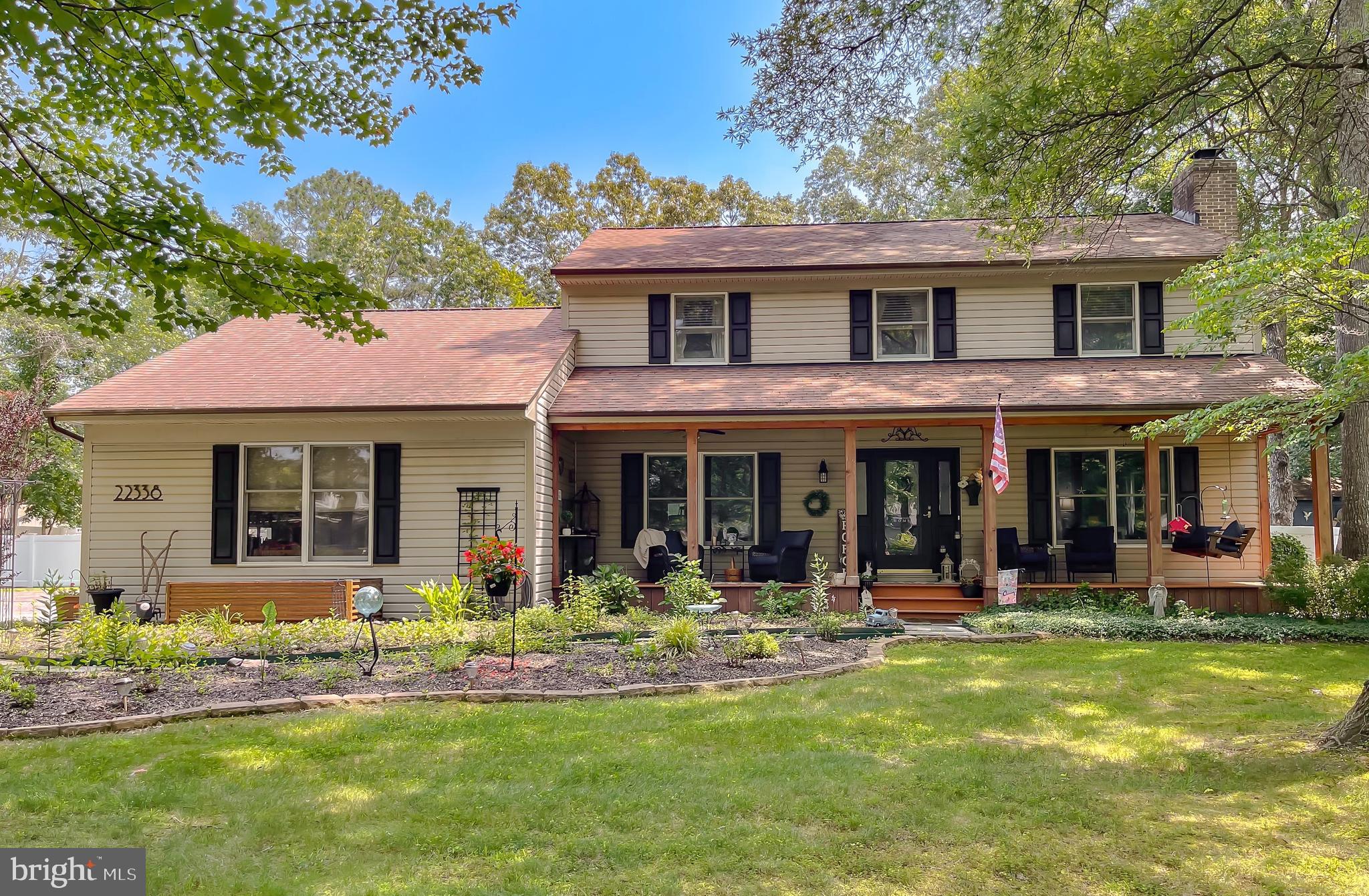 a front view of a house with swimming pool and furniture