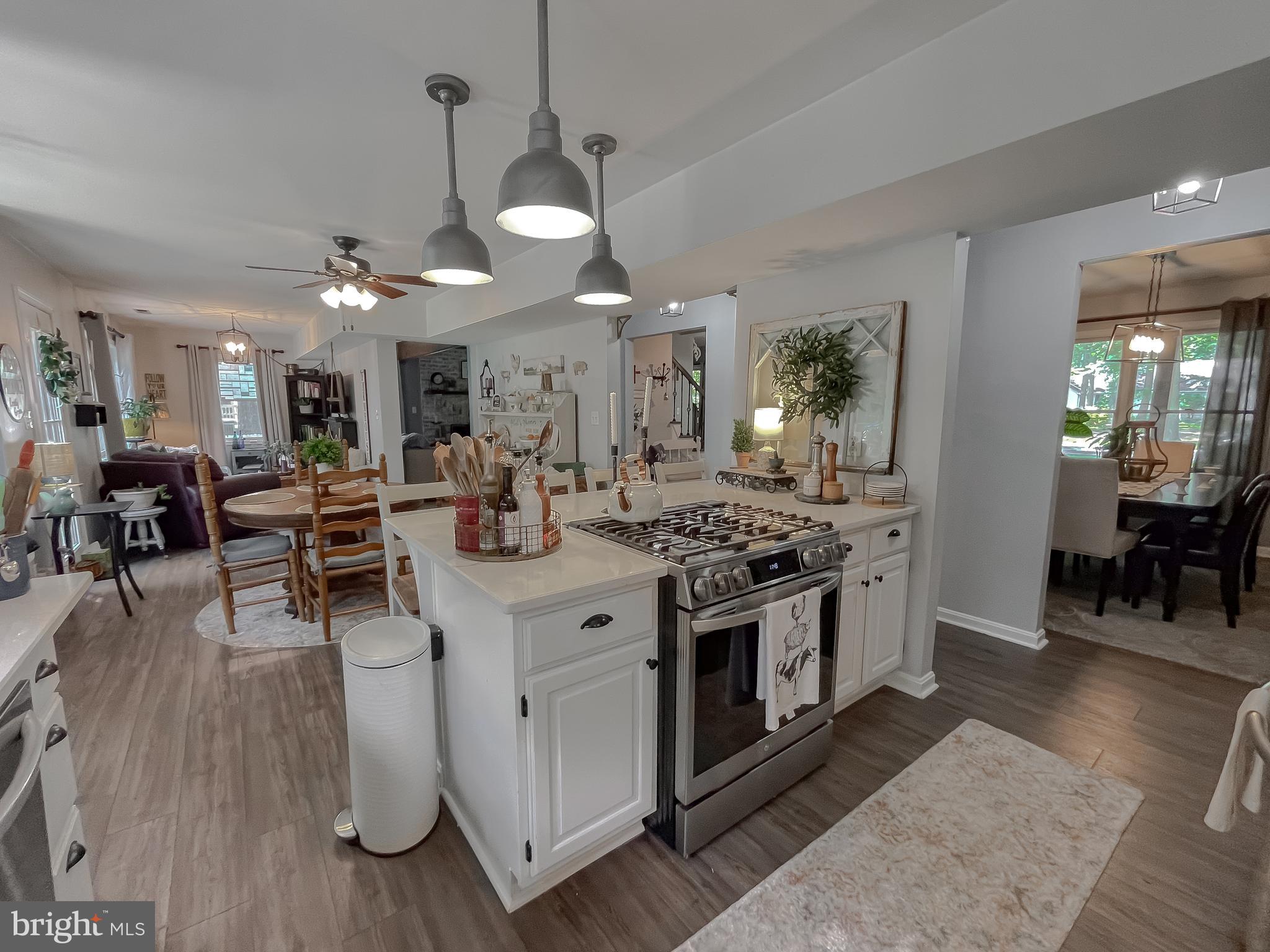 22338 White Oak Road Leonardtown, MD 20650 - Photo 17 of 66 a kitchen with stainless steel appliances a stove oven and a table with chairs
