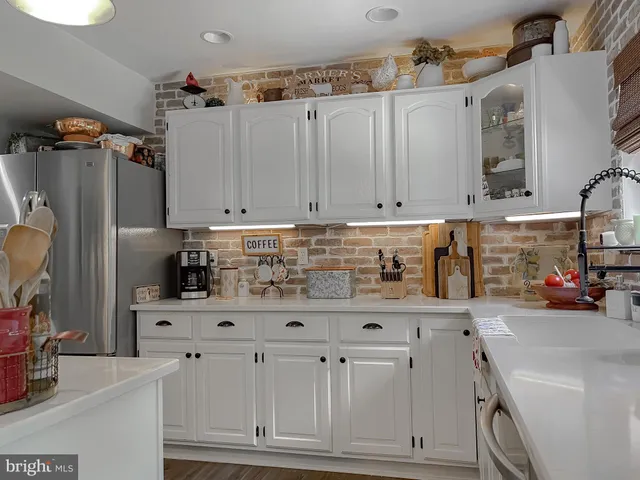 a view of a dining room with furniture a chandelier and wooden floor