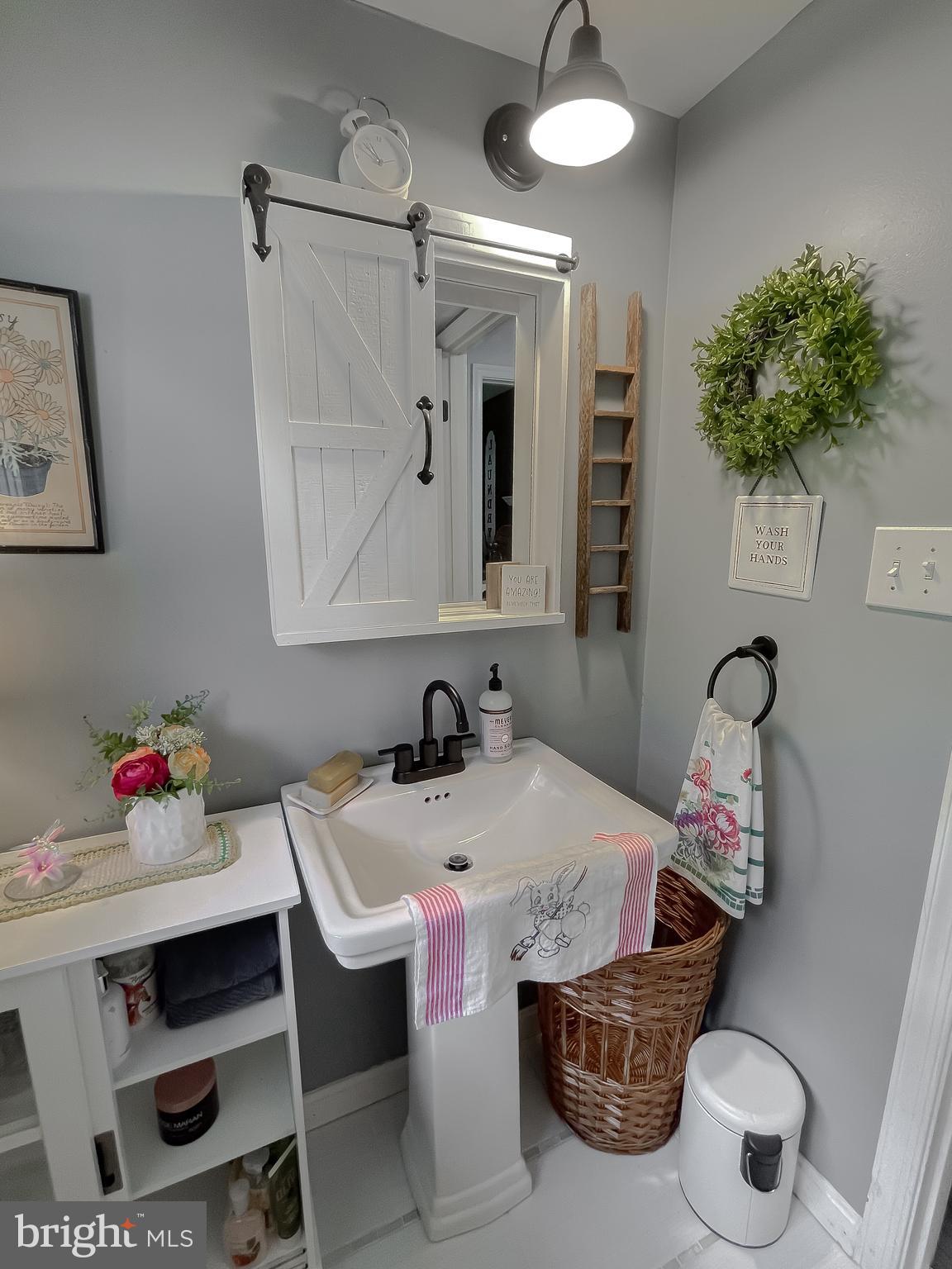 22338 White Oak Road Leonardtown, MD 20650 - Photo 28 of 66 a bathroom with a sink mirror and vanity