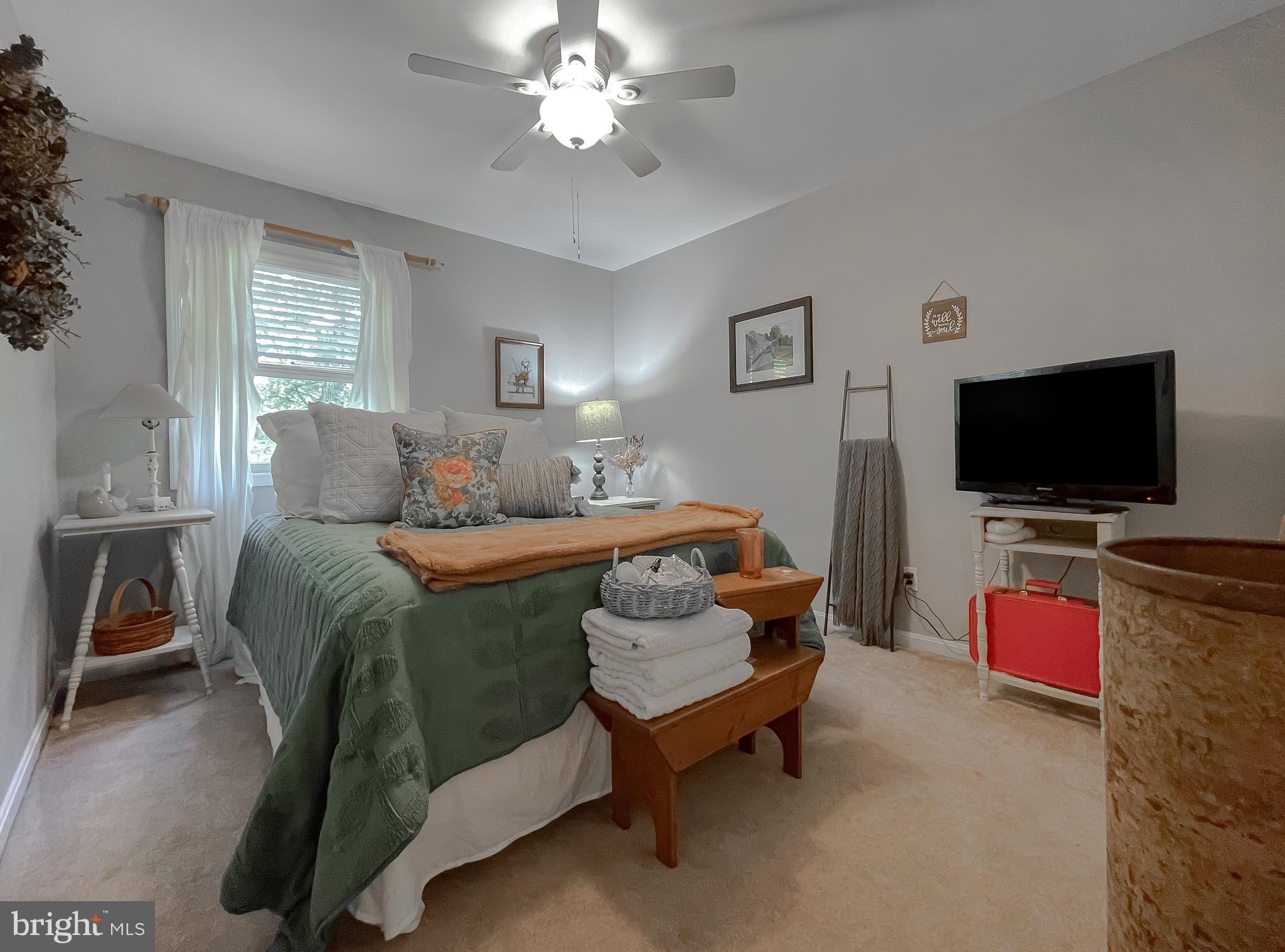22338 White Oak Road Leonardtown, MD 20650 - Photo 29 of 66 a bedroom with a bed and a flat screen tv