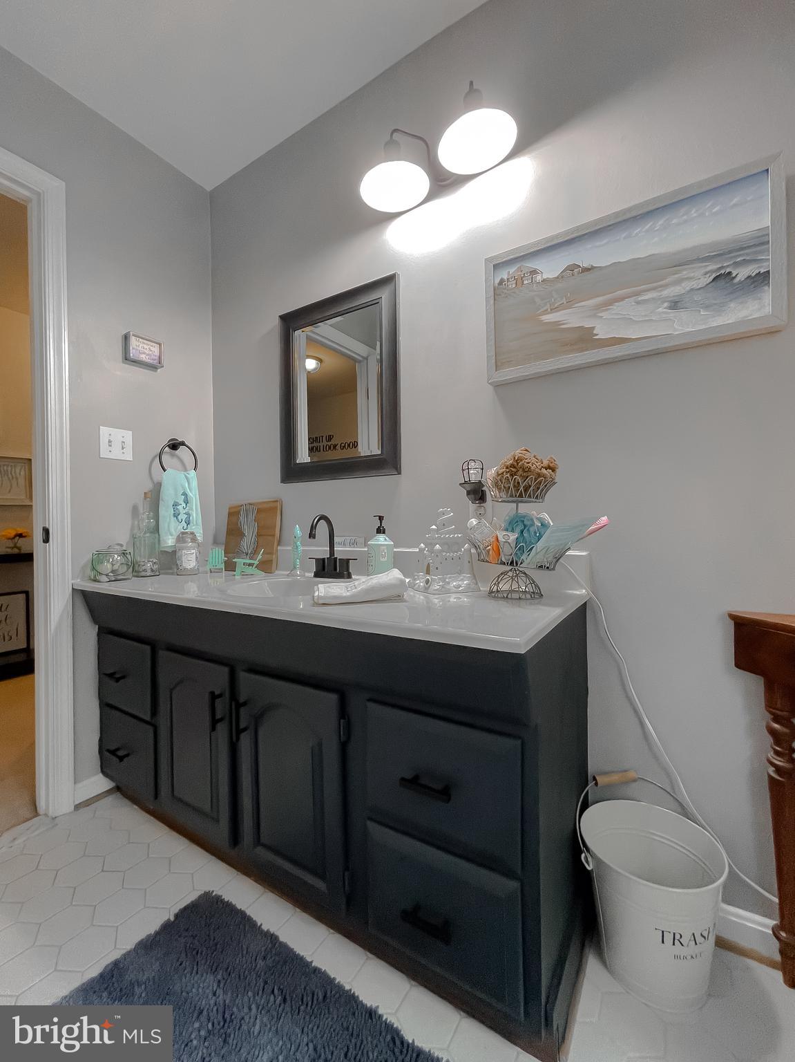 22338 White Oak Road Leonardtown, MD 20650 - Photo 32 of 66 a bathroom with a toilet sink double vanity and mirror