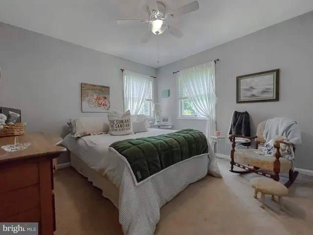 a living room with furniture and chandelier