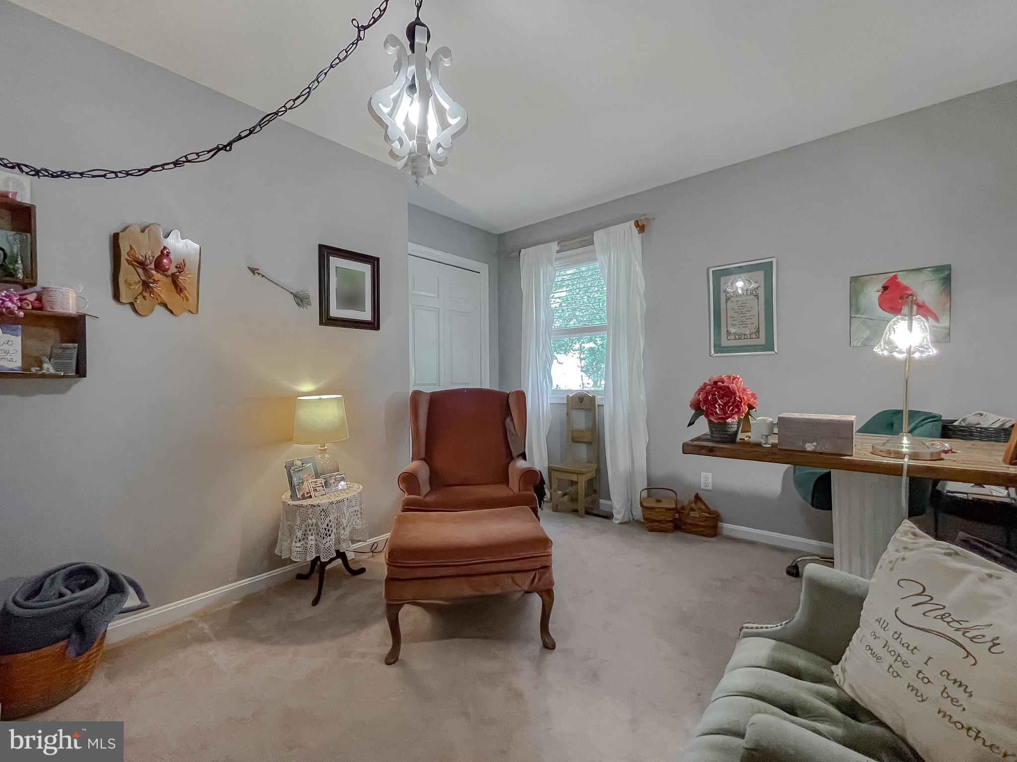 22338 White Oak Road Leonardtown, MD 20650 - Photo 38 of 66 a living room with furniture and a chandelier