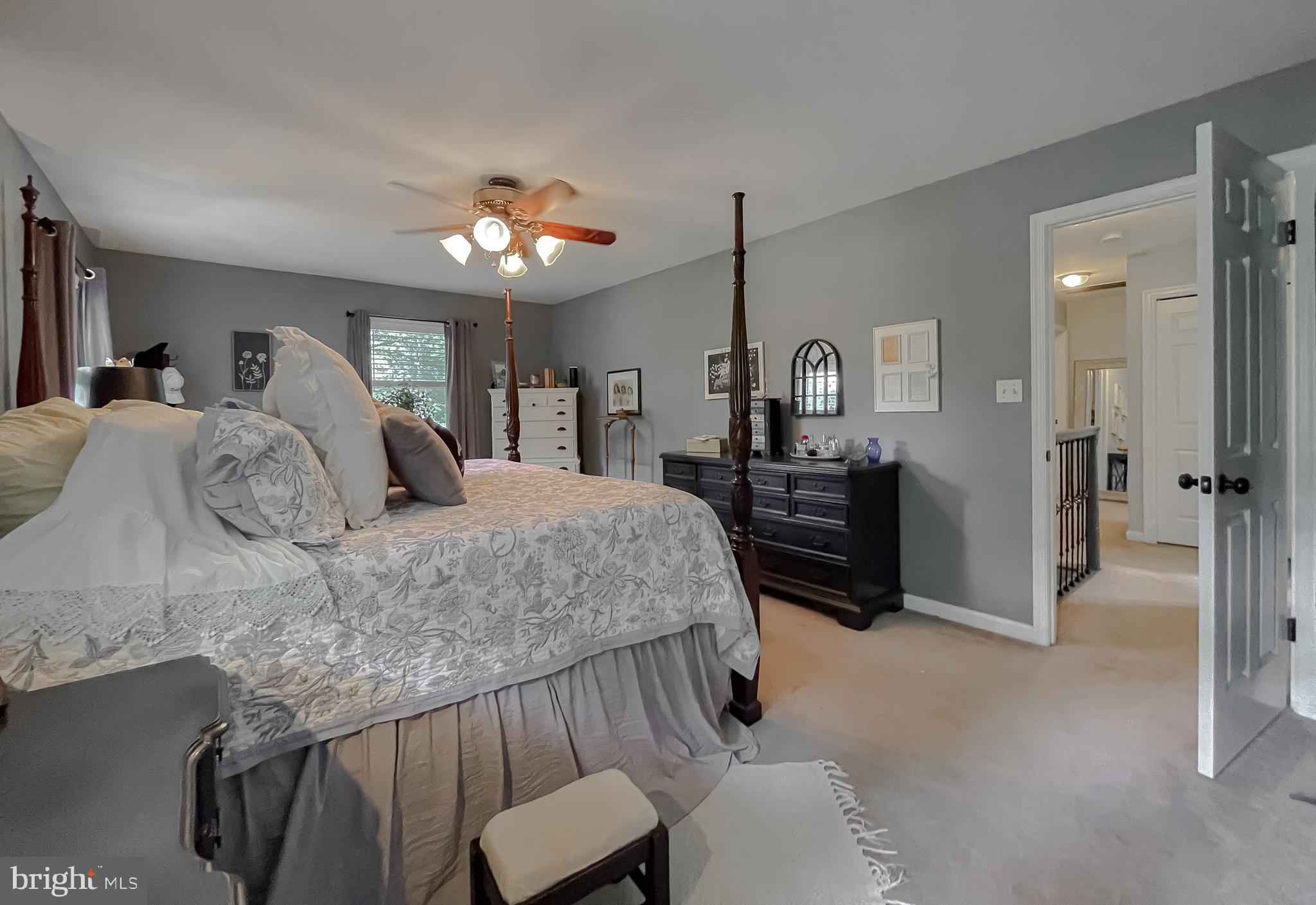 22338 White Oak Road Leonardtown, MD 20650 - Photo 42 of 66 a bedroom with a bed and a chandelier